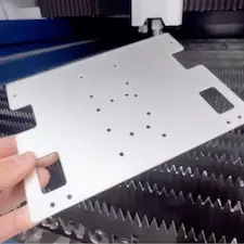 Hand holding a formed sheet metal bracket