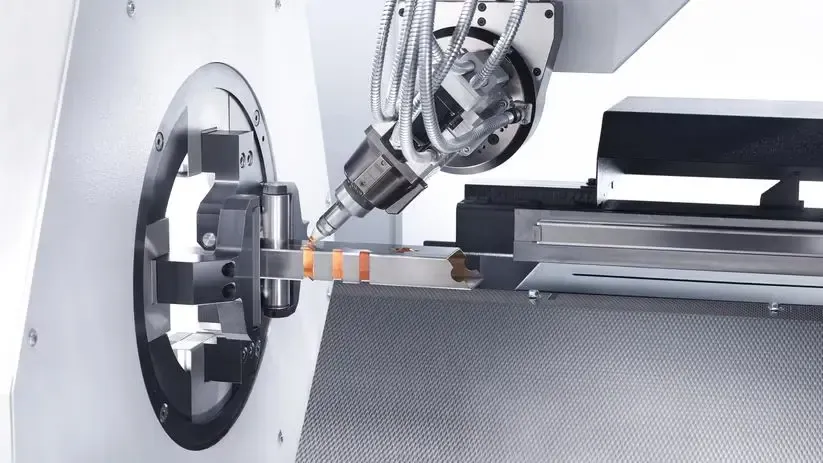 5-axis tube laser cutting head cutting a square aluminum tube with a honeycomb cutting bed behind it